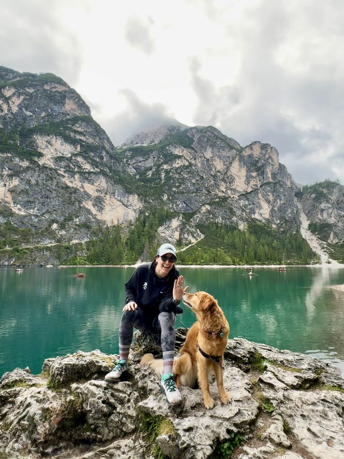 Amy waving with her engagement ring and Holland at Lago di Braies, Italy